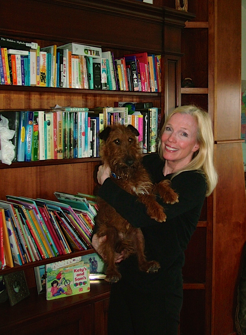 Dr. Christie Kaaland with Bella, her previous Irish terrier, with books in the background